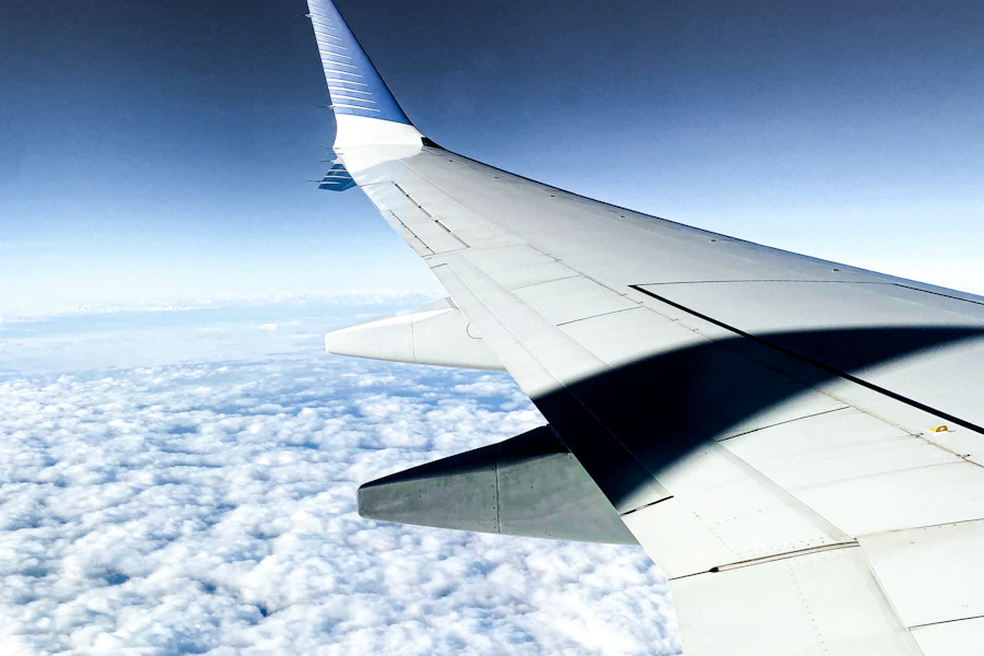 An aeroplane wing above the clouds
